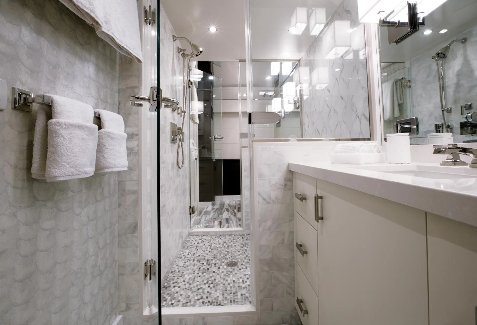 a bathroom with a shower and sink aboard 2021 HATTERAS 105RPH Yacht for Sale