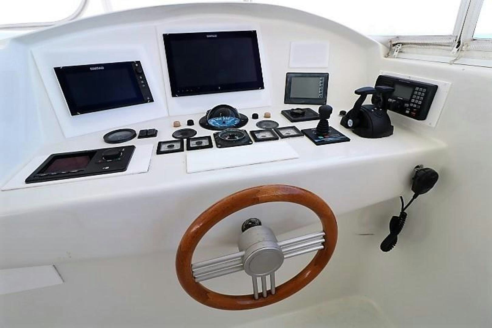 a white electronic device with a round fan and a black speaker on a white surface aboard No Name Yacht for Sale
