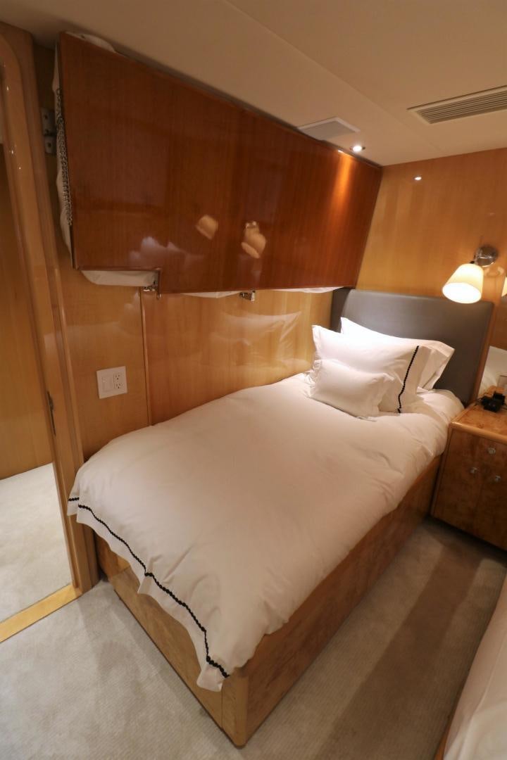 a bed with a white comforter aboard No Name Yacht for Sale