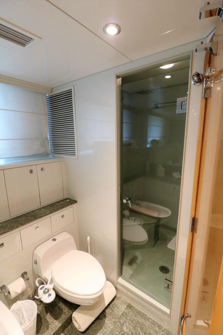 a bathroom with a glass shower door aboard No Name Yacht for Sale