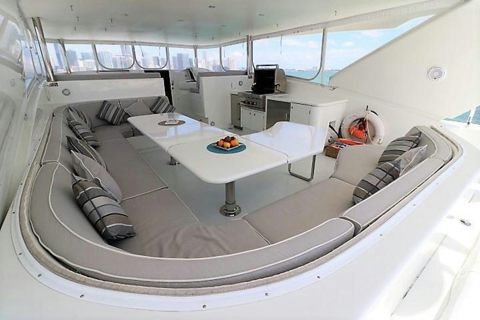 a room with a large white table and chairs aboard No Name Yacht for Sale
