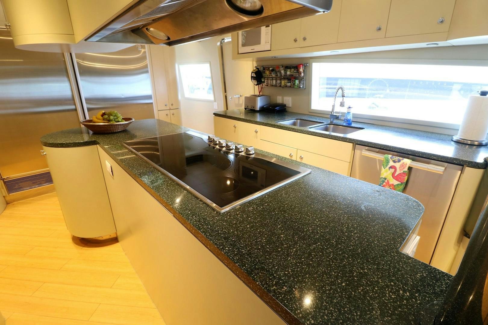 a kitchen with a black countertop aboard No Name Yacht for Sale