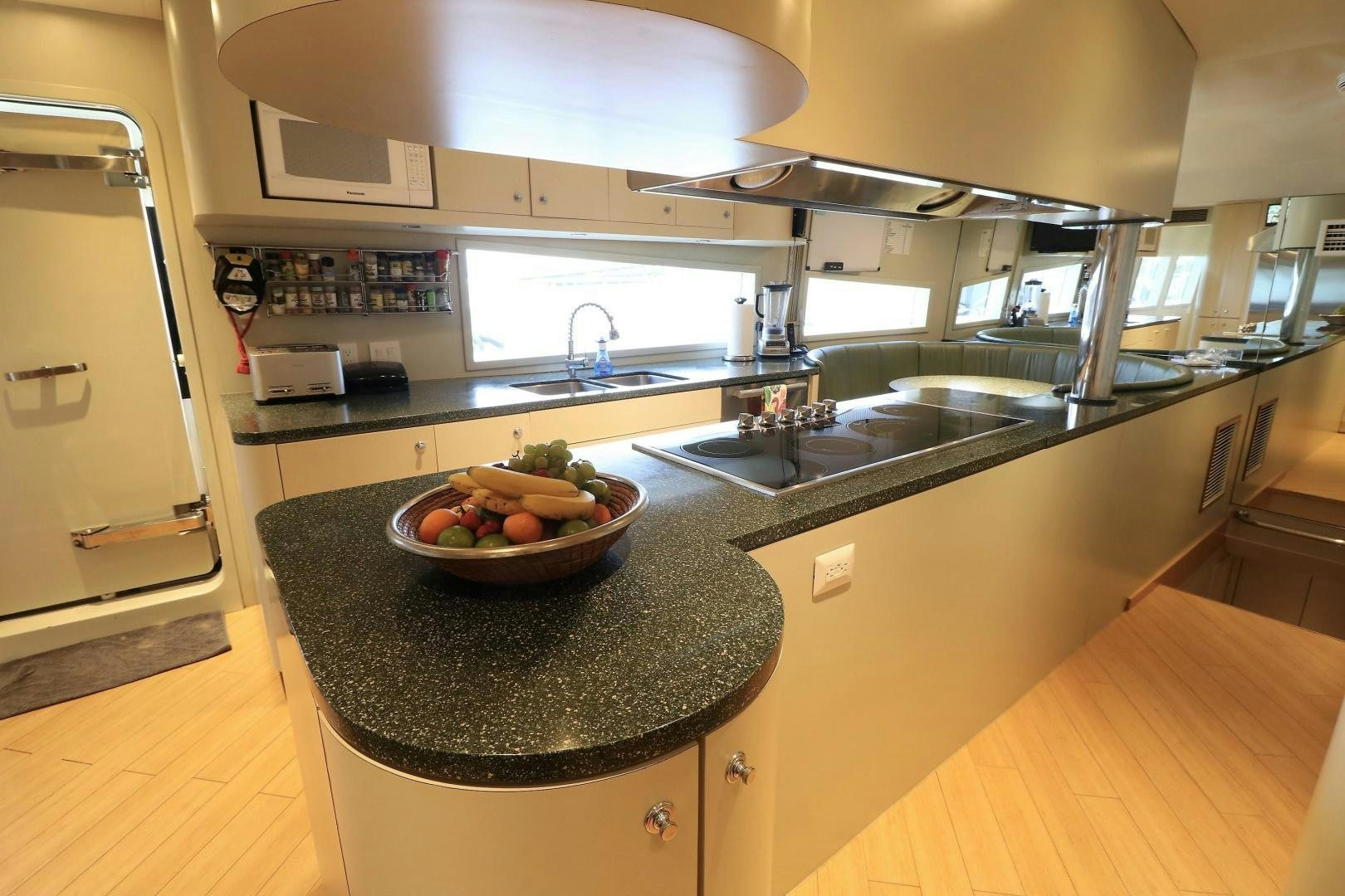 a kitchen with a bowl of fruit aboard No Name Yacht for Sale