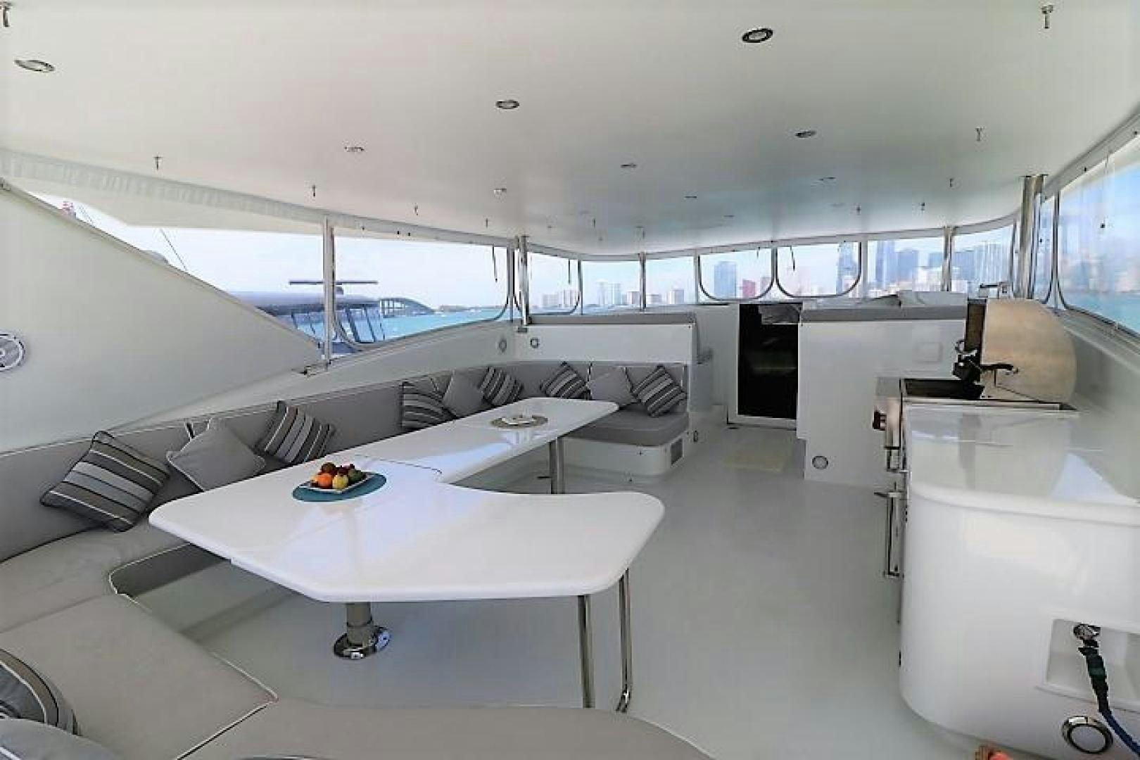 a room with white tables and chairs aboard No Name Yacht for Sale