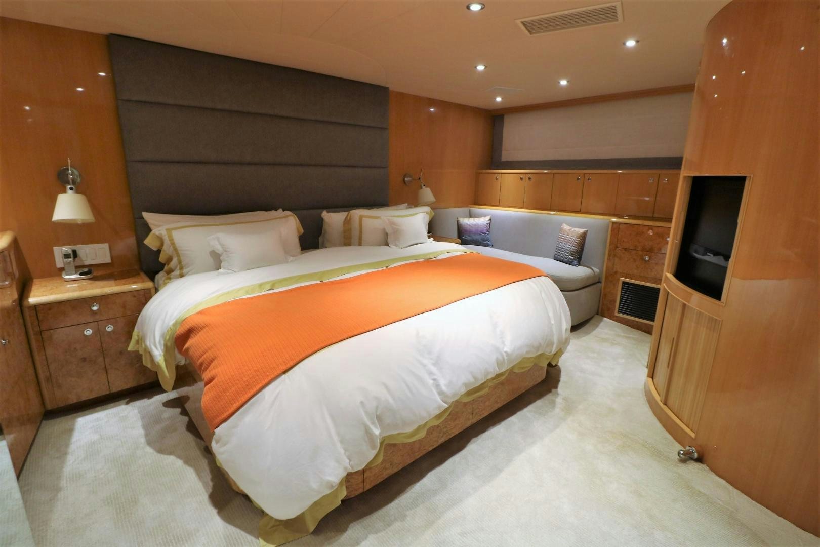 a bedroom with a bed and a television aboard No Name Yacht for Sale