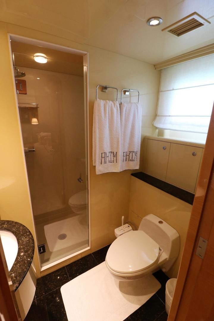 a bathroom with a toilet and a washer aboard No Name Yacht for Sale