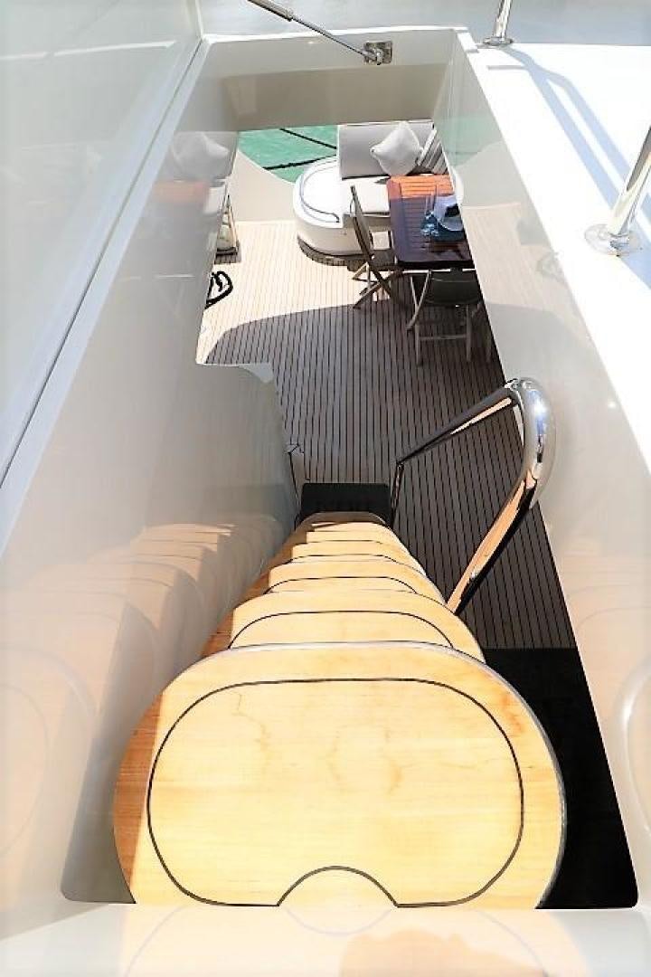 a bed with a desk and a chair aboard No Name Yacht for Sale