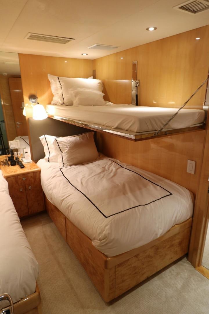 a bed with a mirror above it aboard No Name Yacht for Sale
