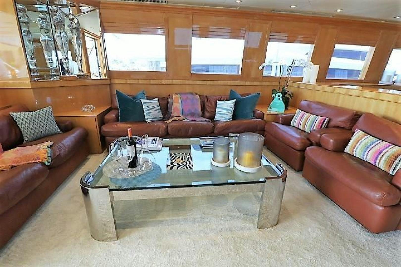 a living room with a table and couches aboard No Name Yacht for Sale