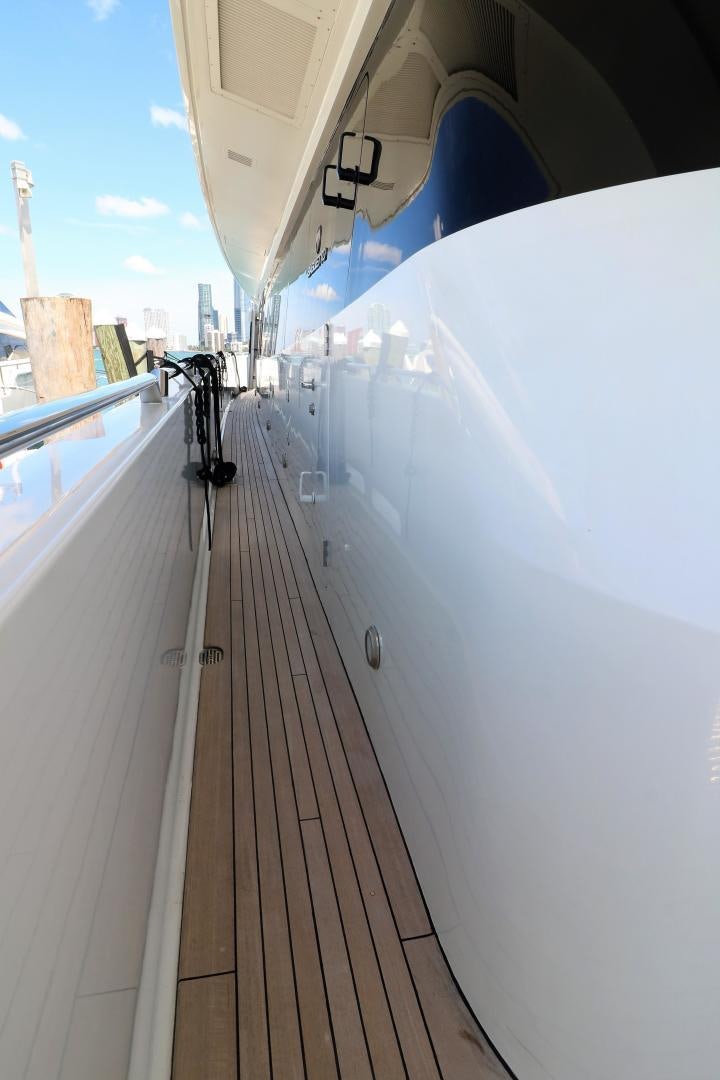 a white boat on a dock aboard No Name Yacht for Sale