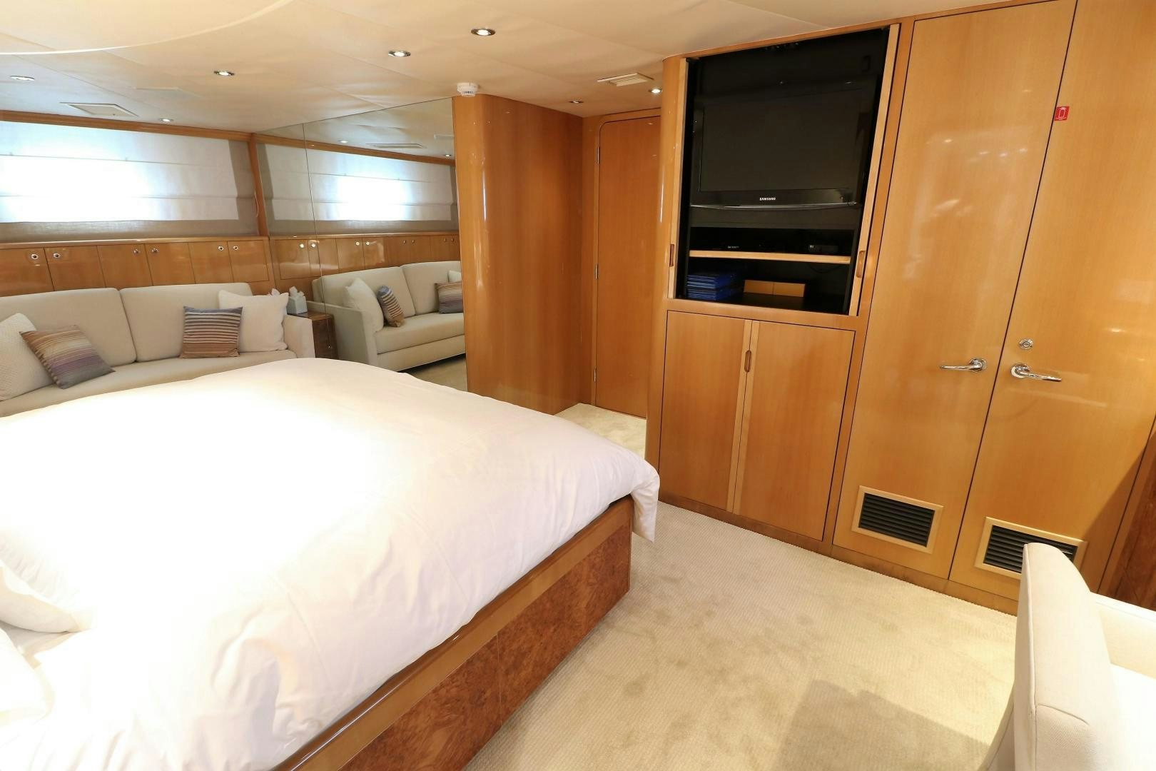 a room with a bed and a television aboard No Name Yacht for Sale