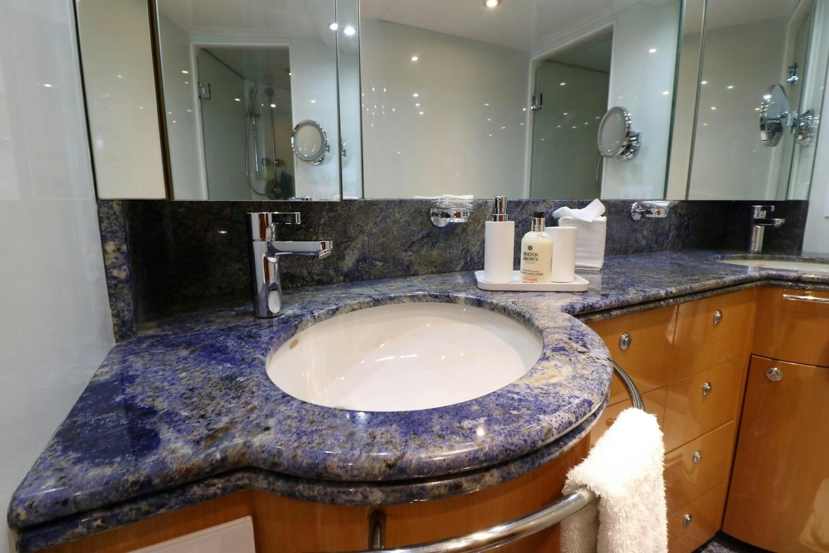 a bathroom with a sink and a large mirror aboard No Name Yacht for Sale
