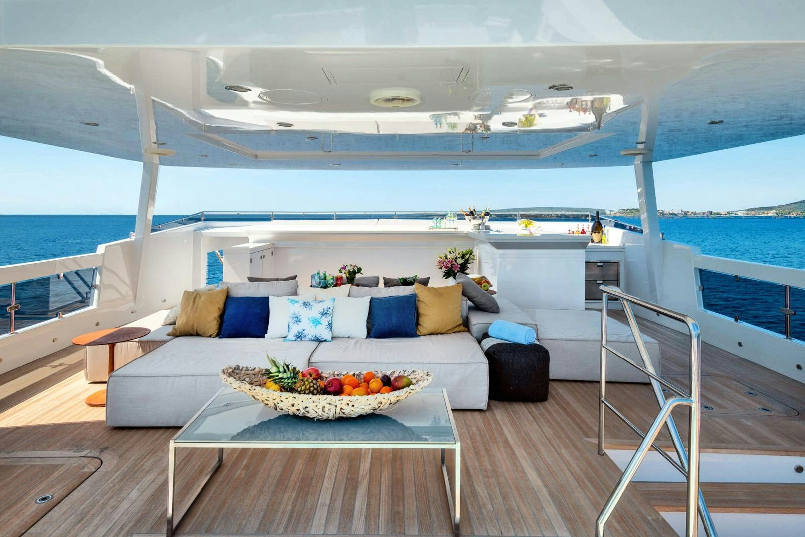 a living room with a large white sofa and a table aboard CURFEW II Yacht for Sale