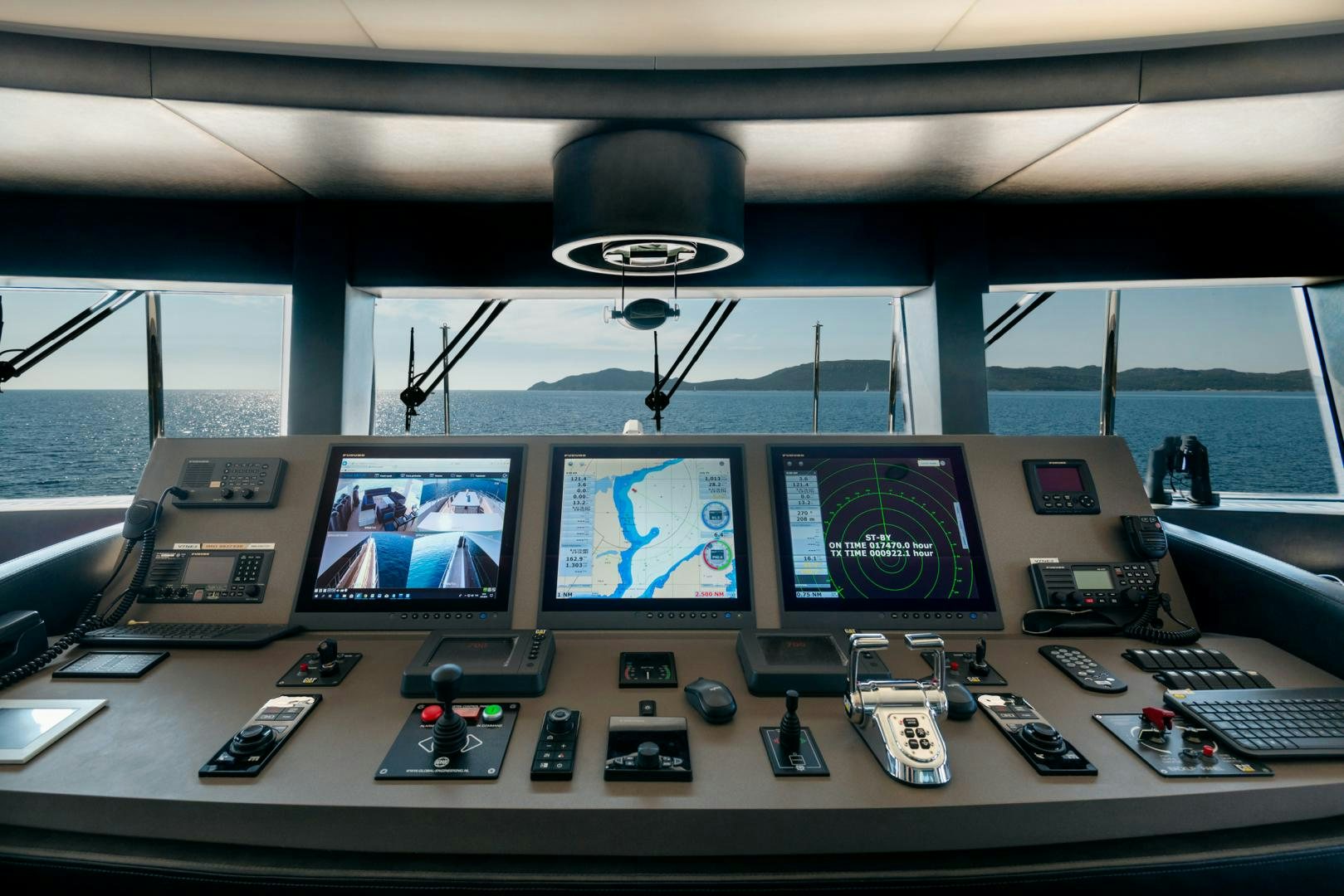 a control panel with a group of monitors and a keyboard aboard CURFEW II Yacht for Sale