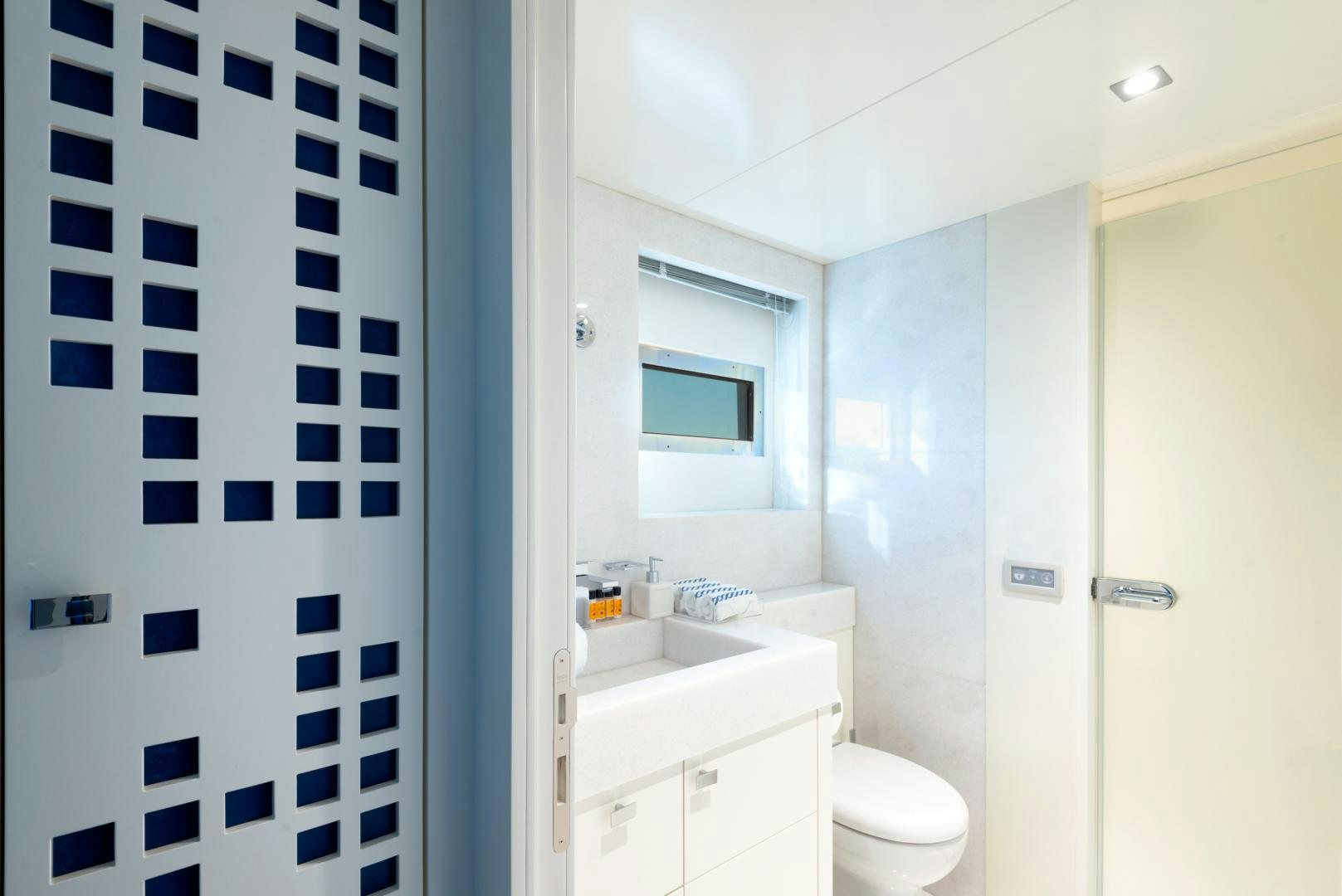 a bathroom with a white toilet and sink aboard CURFEW II Yacht for Sale