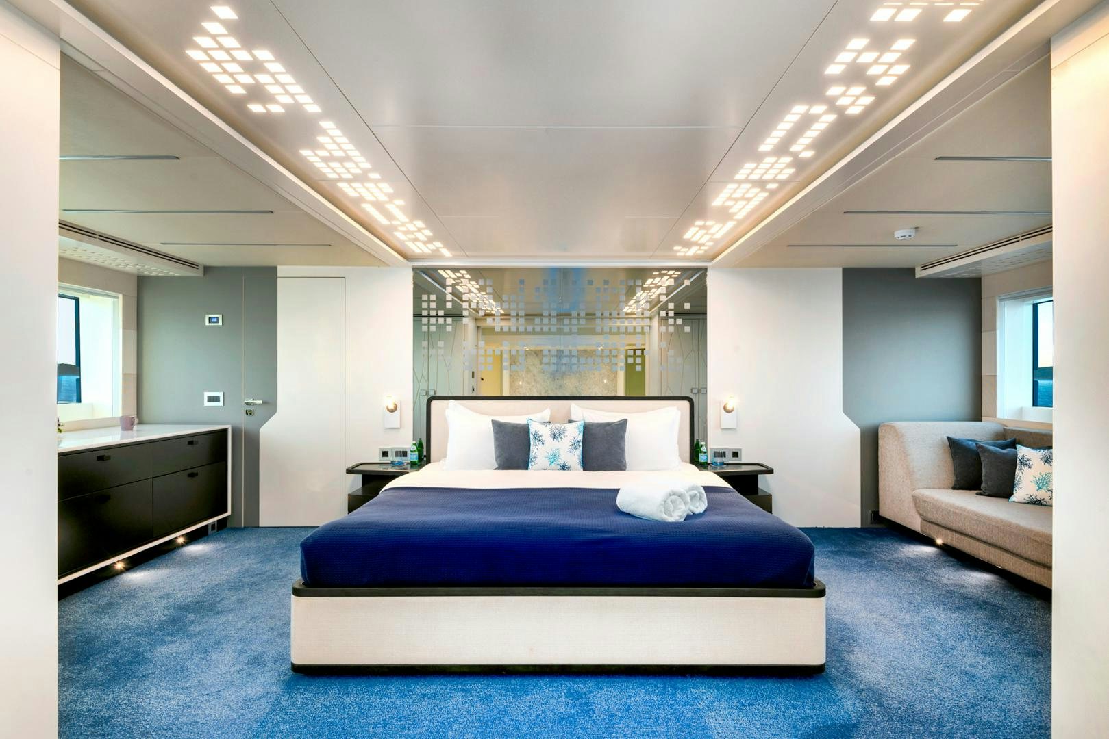 a bedroom with a bed and a couch aboard CURFEW II Yacht for Sale