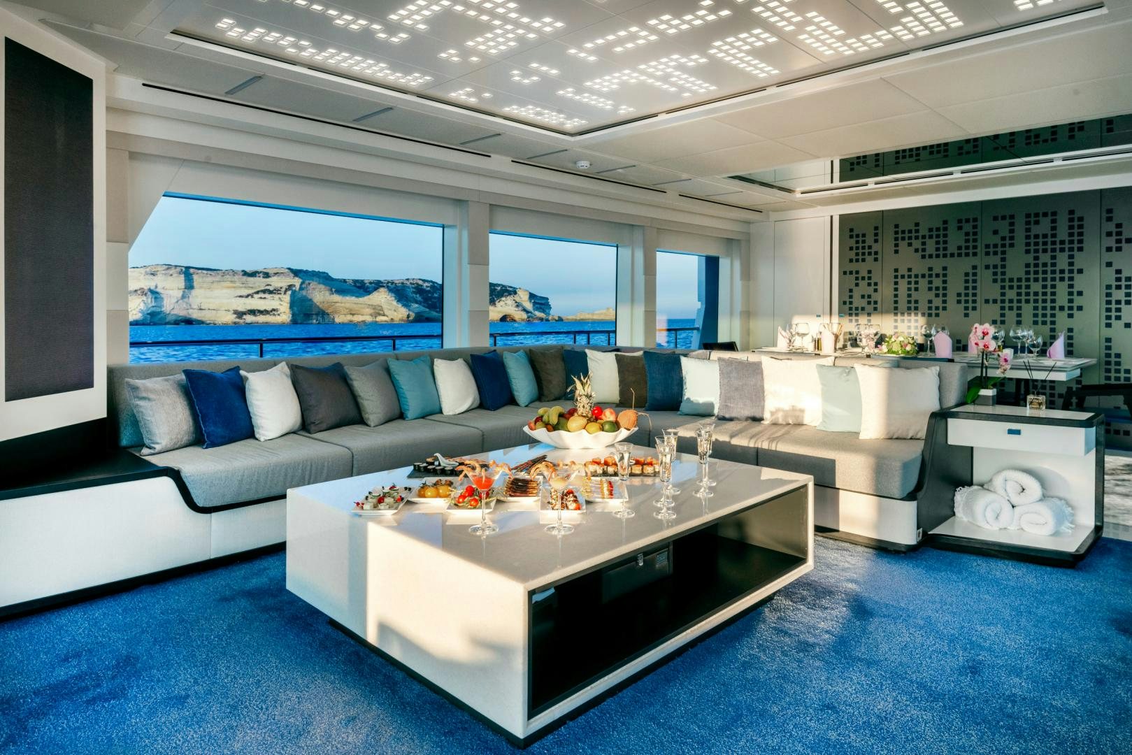 a living room with a large blue rug and a white couch aboard CURFEW II Yacht for Sale