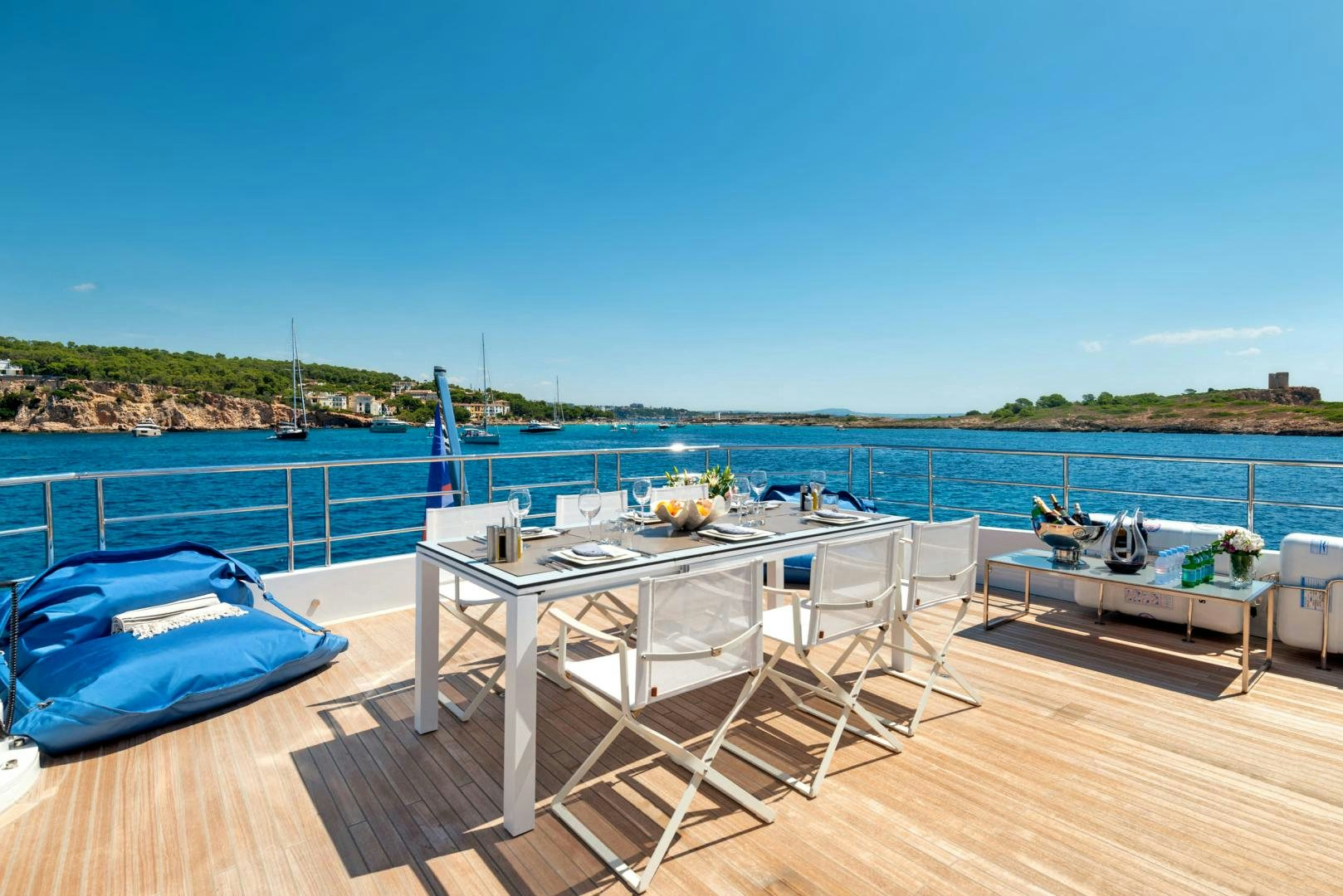 a deck with chairs on it by a body of water aboard CURFEW II Yacht for Sale