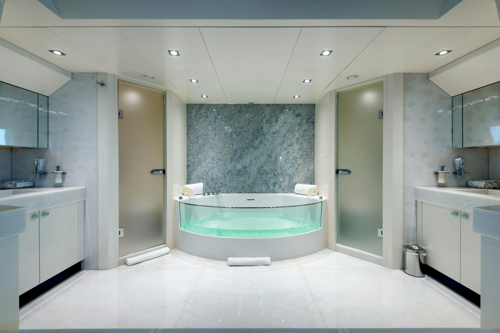 a bathroom with a tub and a shower aboard CURFEW II Yacht for Sale