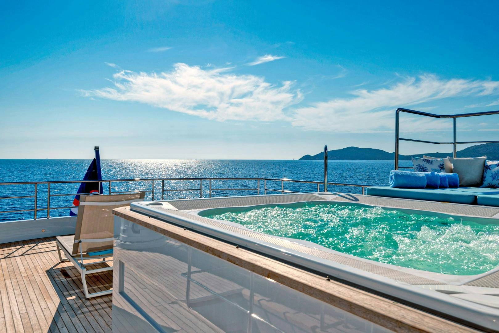 a deck with a pool and a view of the ocean aboard CURFEW II Yacht for Sale