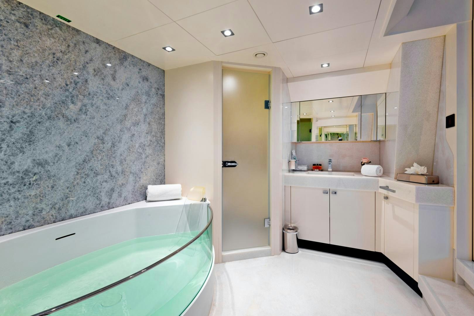 a bathroom with a tub sink and a large marble wall aboard CURFEW II Yacht for Sale