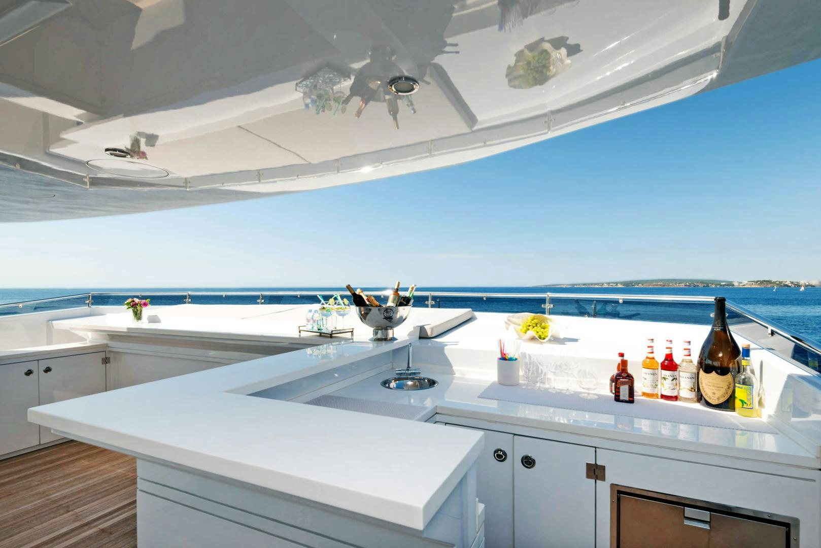a kitchen with a large white countertop and a white ceiling aboard CURFEW II Yacht for Sale