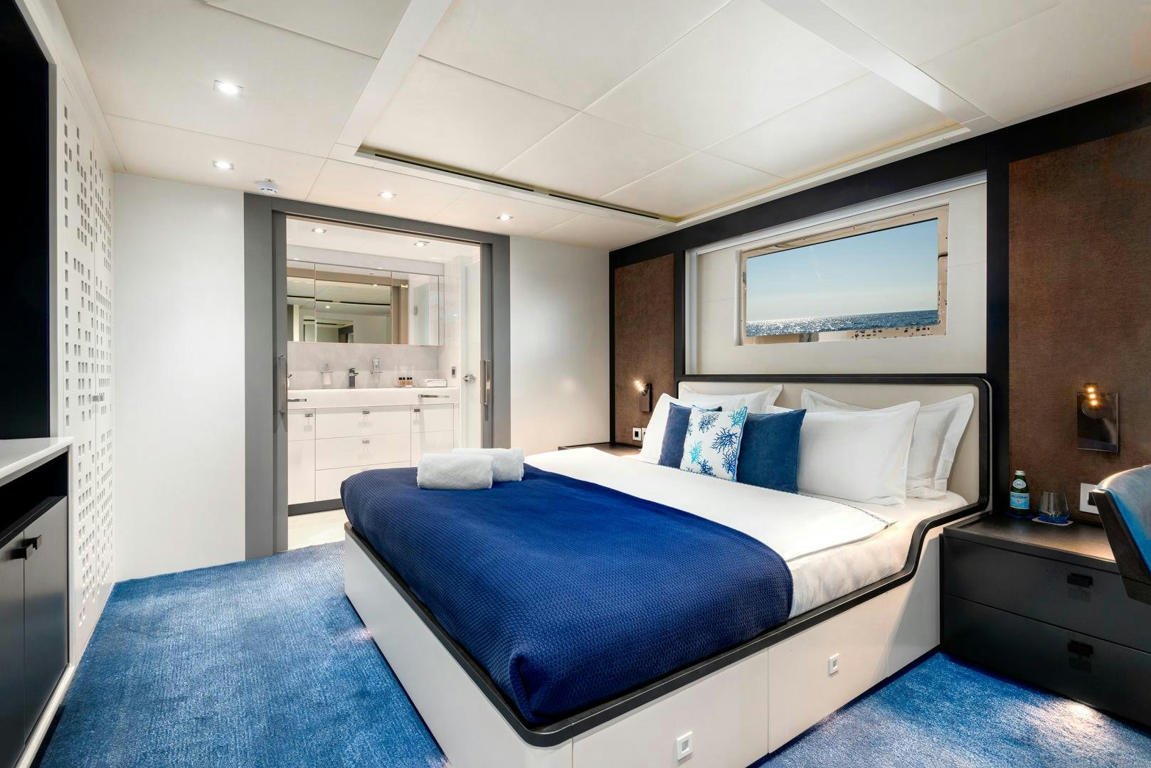 a bedroom with a bed and a desk aboard CURFEW II Yacht for Sale
