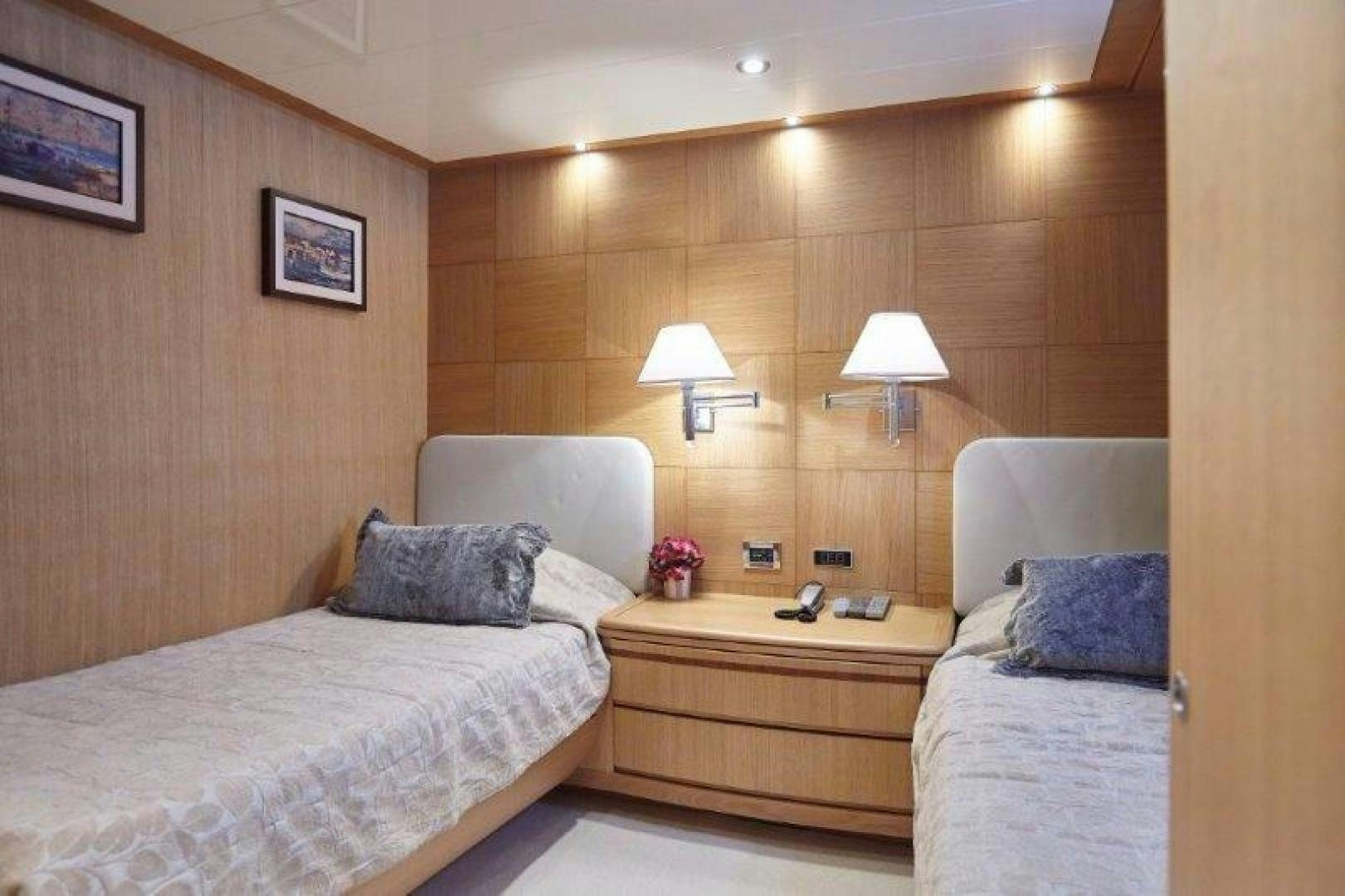 a room with two beds and a lamp aboard YASSON Yacht for Sale