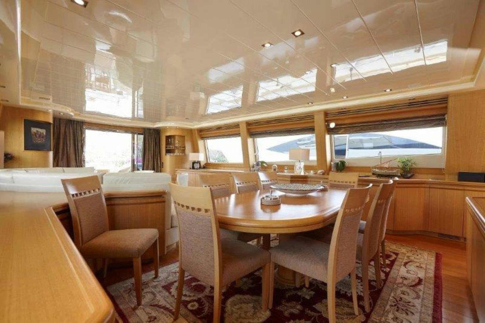 a room with tables and chairs aboard YASSON Yacht for Sale