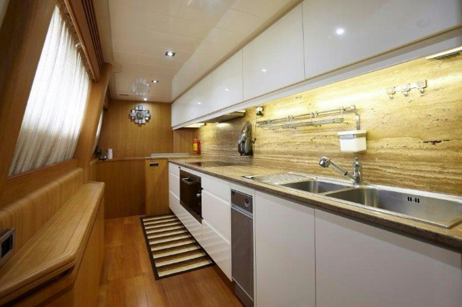a kitchen with white cabinets aboard YASSON Yacht for Sale