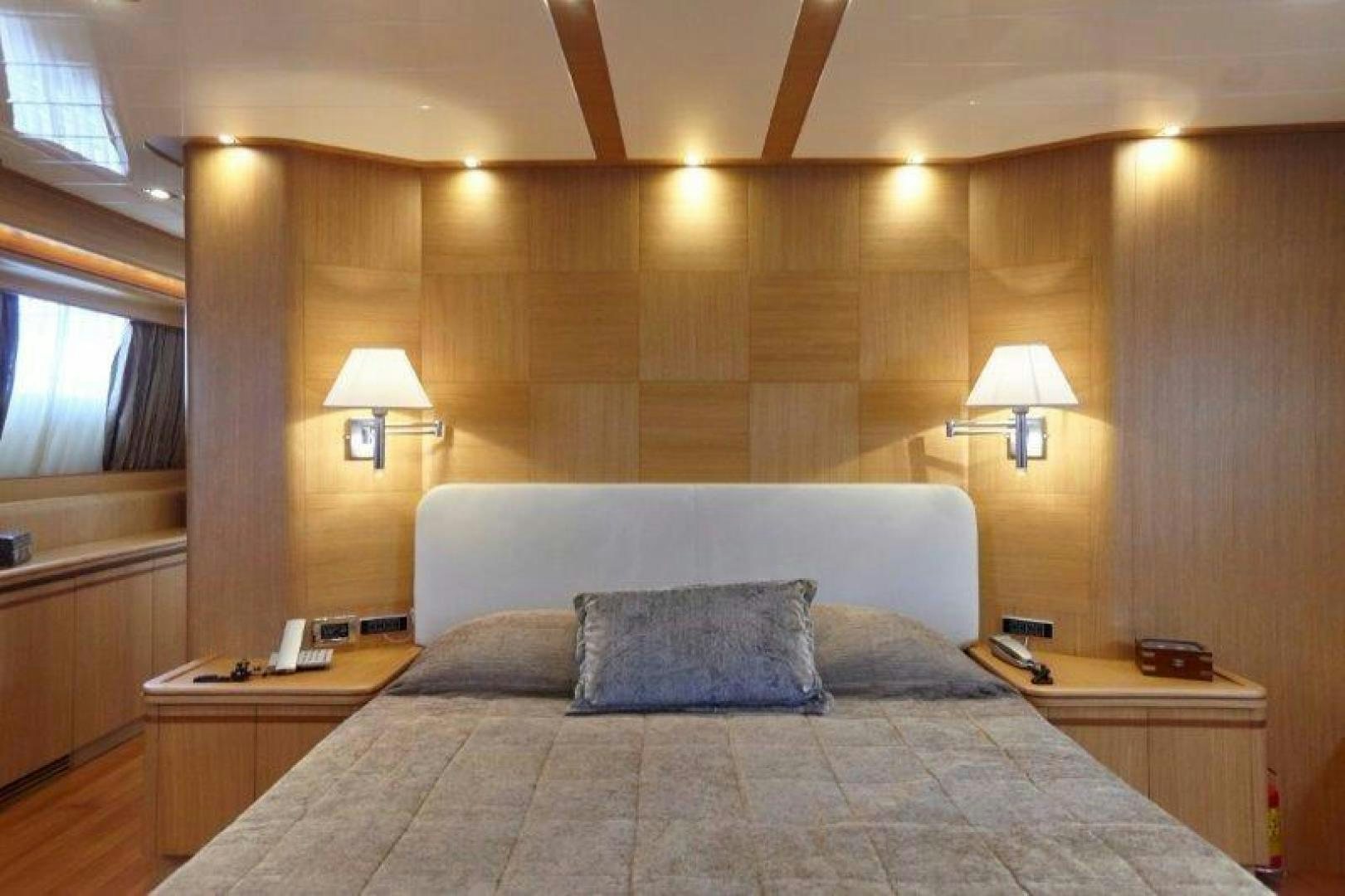 a bed with a pillow and a lamp in a room aboard YASSON Yacht for Sale