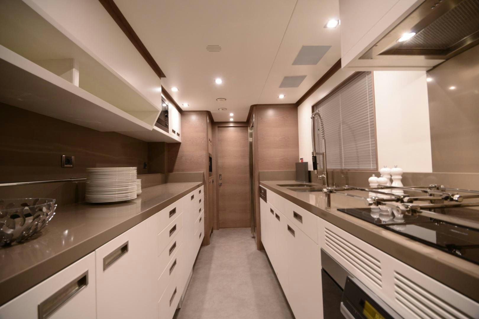 a kitchen with white cabinets aboard No Name Yacht for Sale