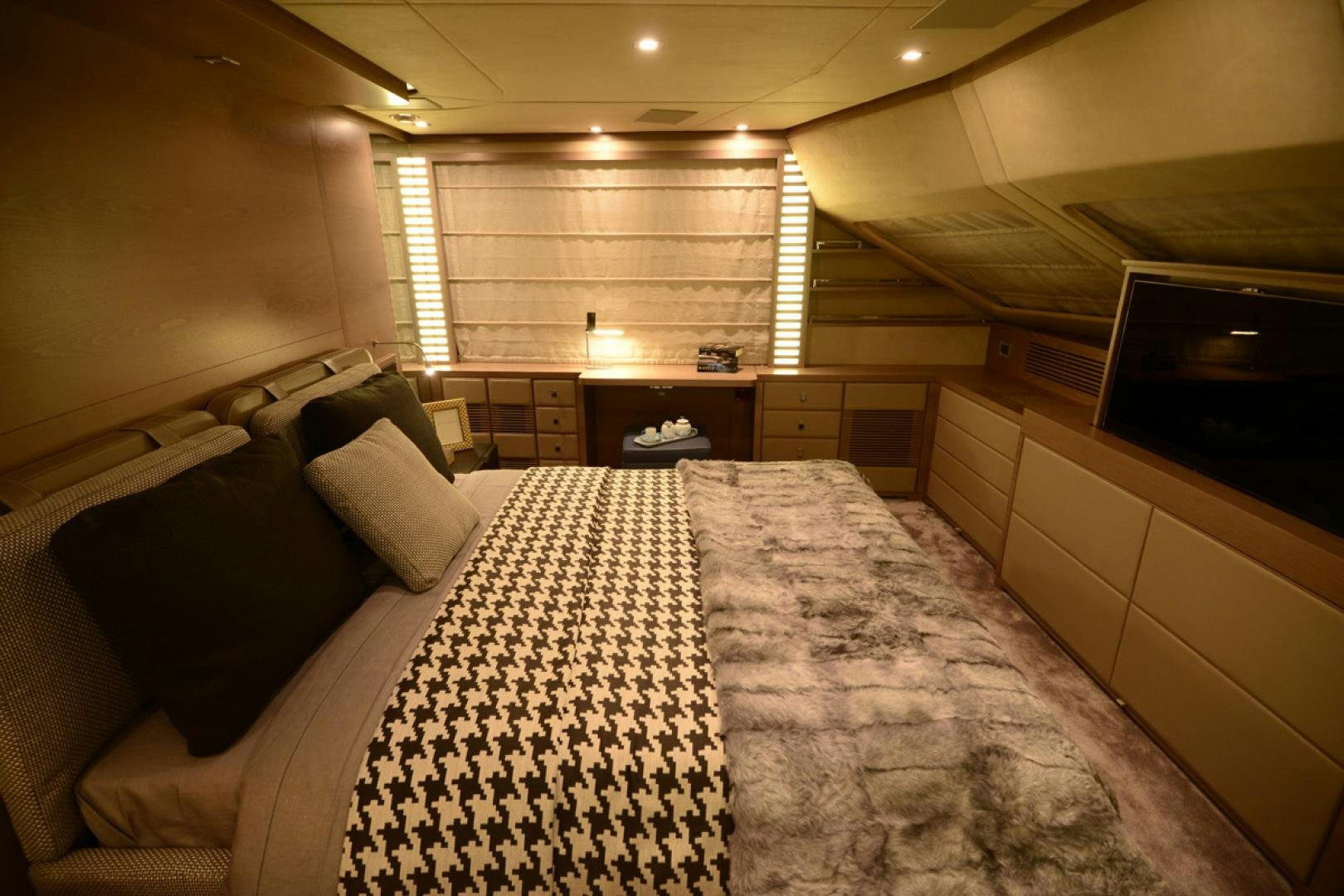 a room with a bed and a television aboard No Name Yacht for Sale