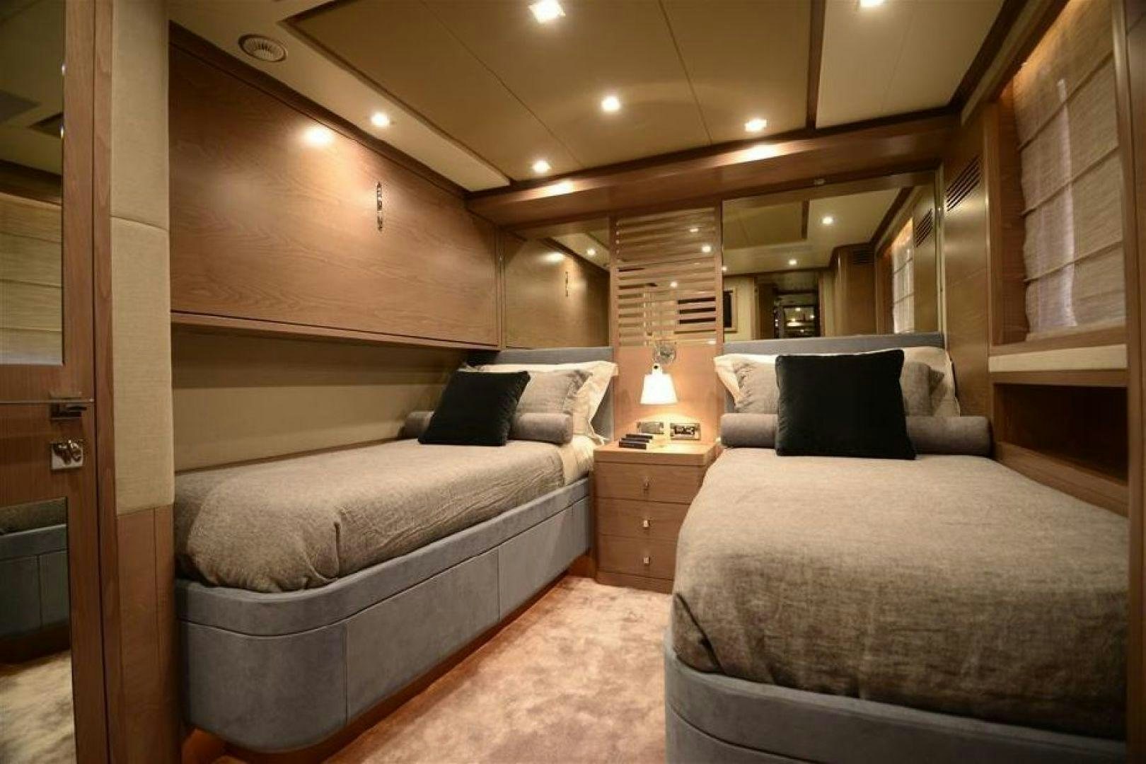 a bedroom with a bed and a couch aboard No Name Yacht for Sale