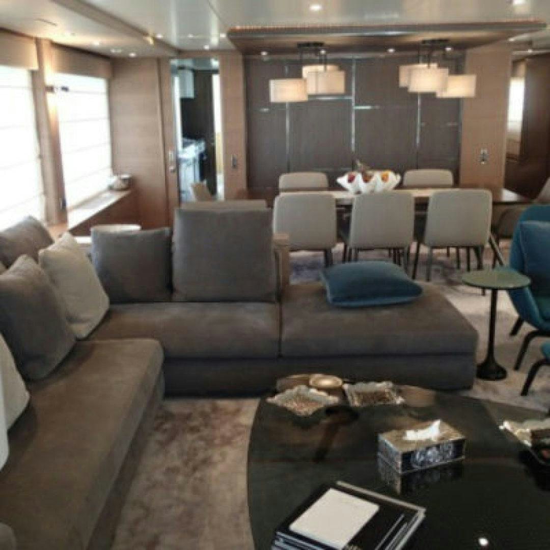 a living room with a couch and chairs aboard No Name Yacht for Sale