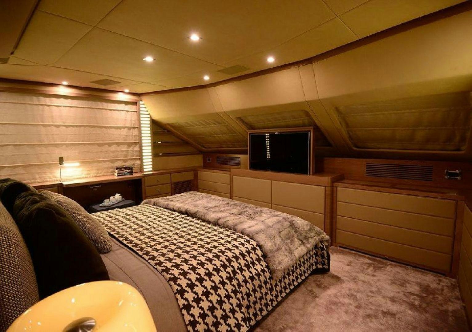 a room with a bed and a television aboard No Name Yacht for Sale