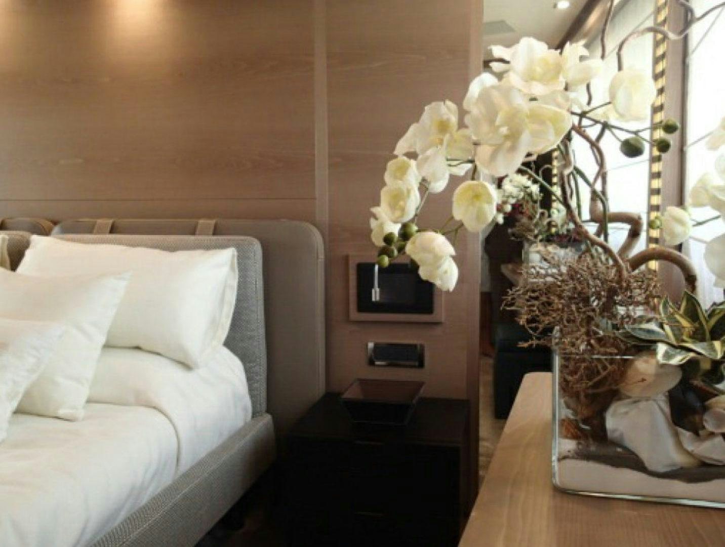 a vase of white flowers on a table aboard No Name Yacht for Sale