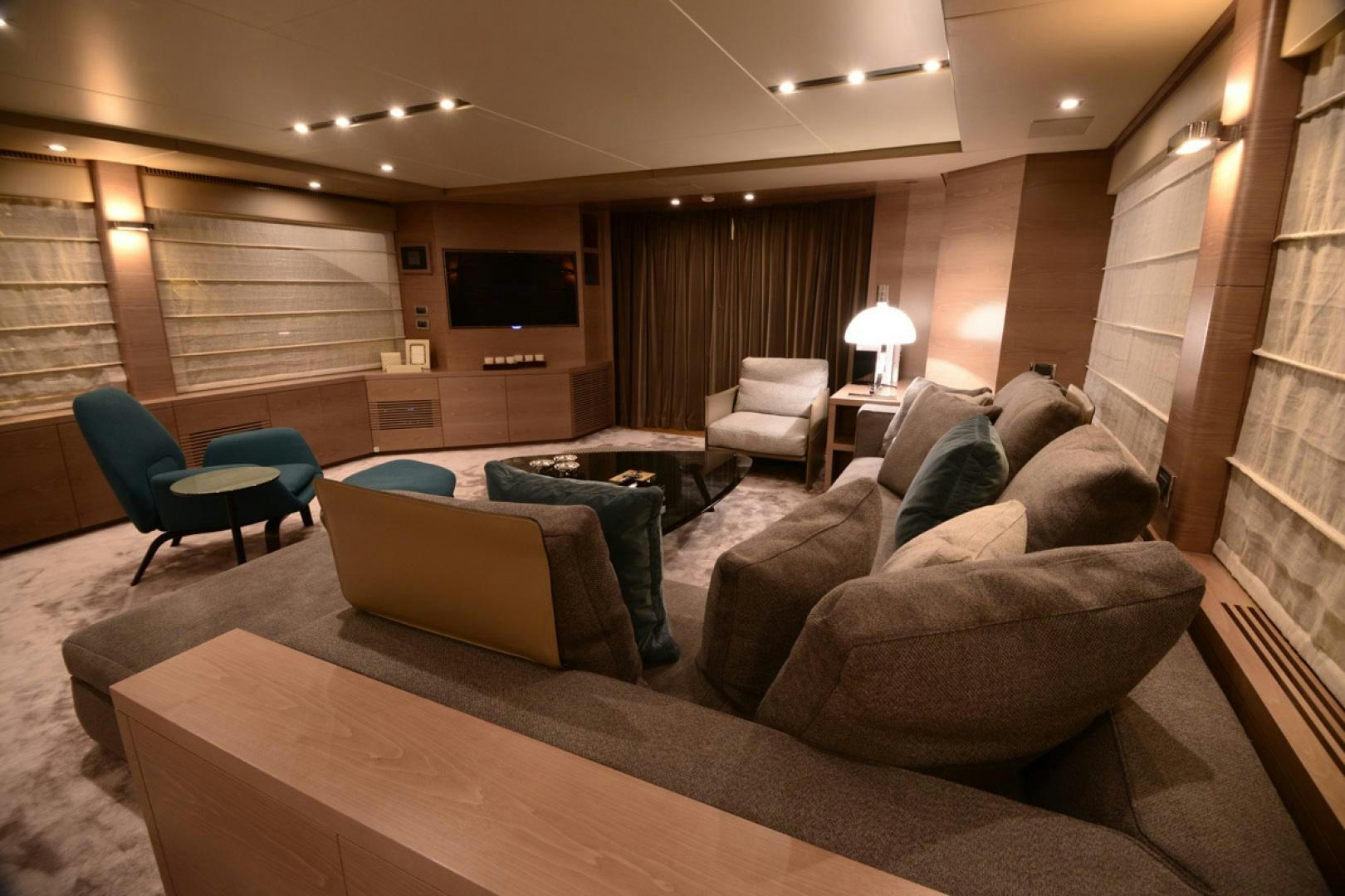 a living room with a couch and a tv aboard No Name Yacht for Sale