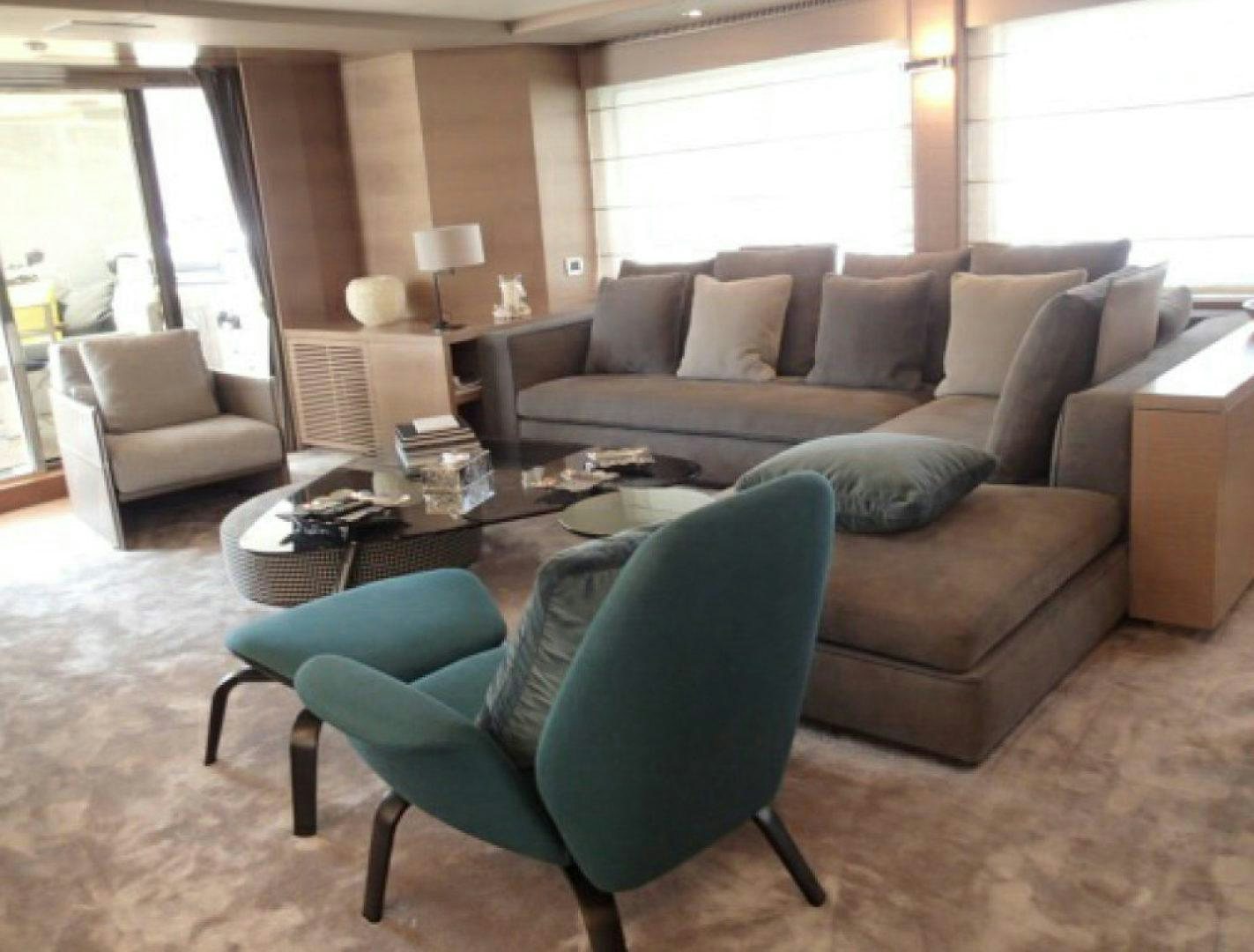 a living room with a couch and a coffee table aboard No Name Yacht for Sale