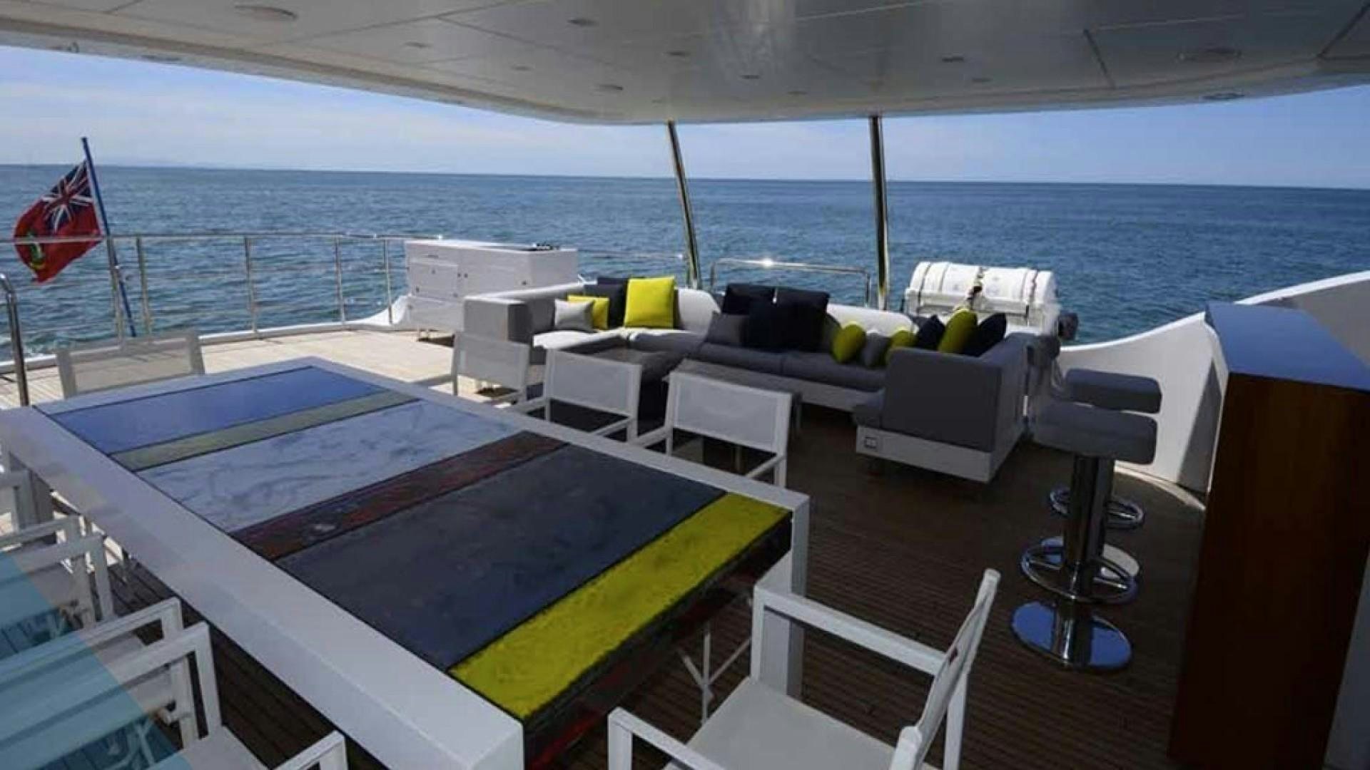 a deck with a pool and chairs on it aboard No Name Yacht for Sale