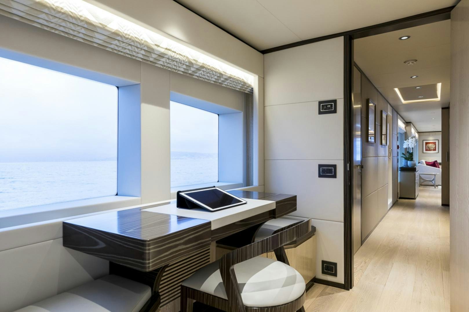 a room with a table and chairs aboard MAJESTY 100 Yacht for Sale