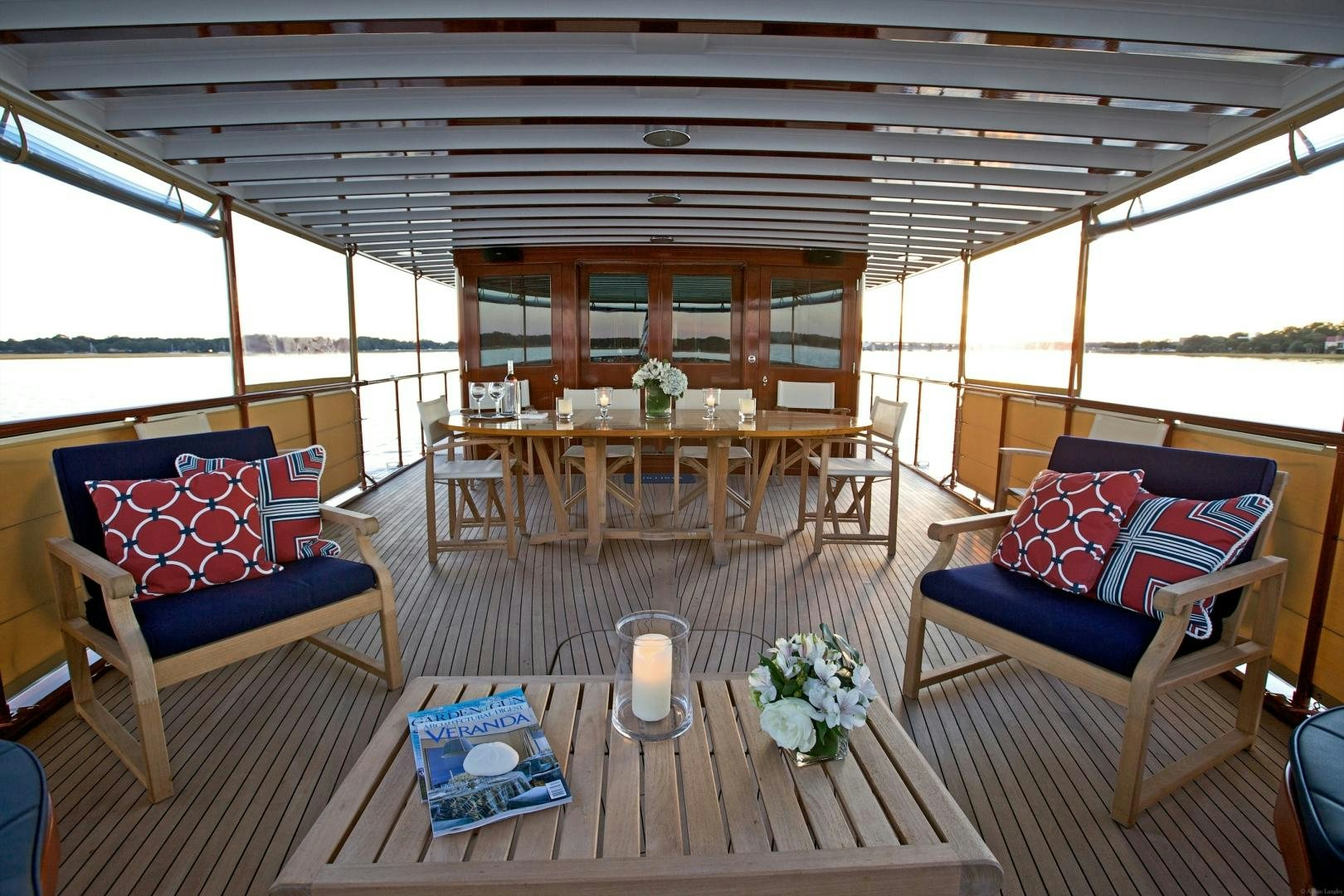 a large patio with a table and chairs and a large window aboard FREEDOM Yacht for Sale
