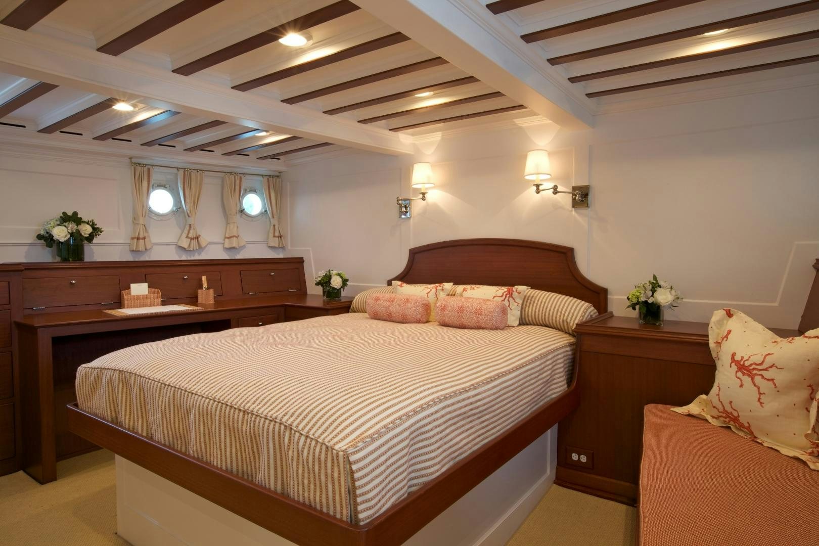 a bedroom with a bed and desk aboard FREEDOM Yacht for Sale