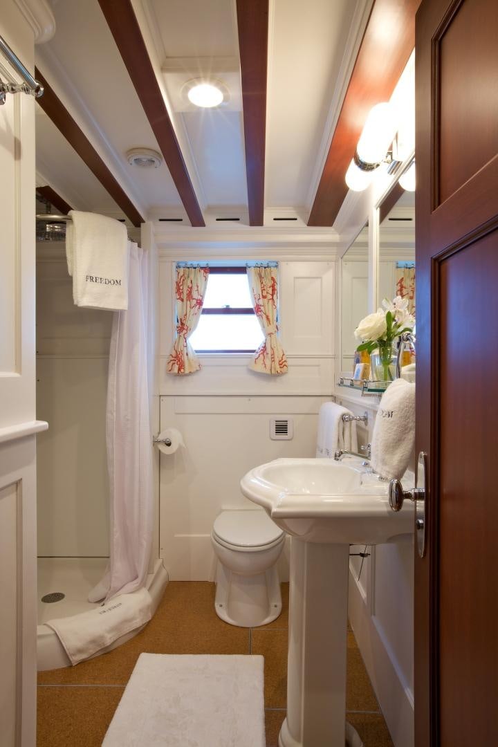 a bathroom with a sink toilet and a mirror aboard FREEDOM Yacht for Sale