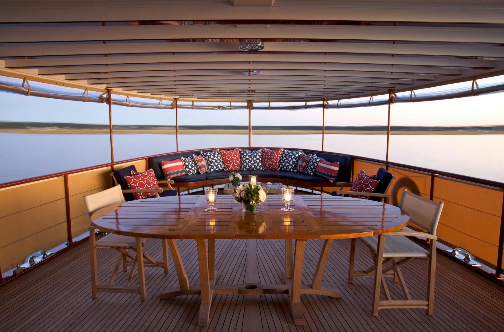 a room with a table and chairs aboard FREEDOM Yacht for Sale