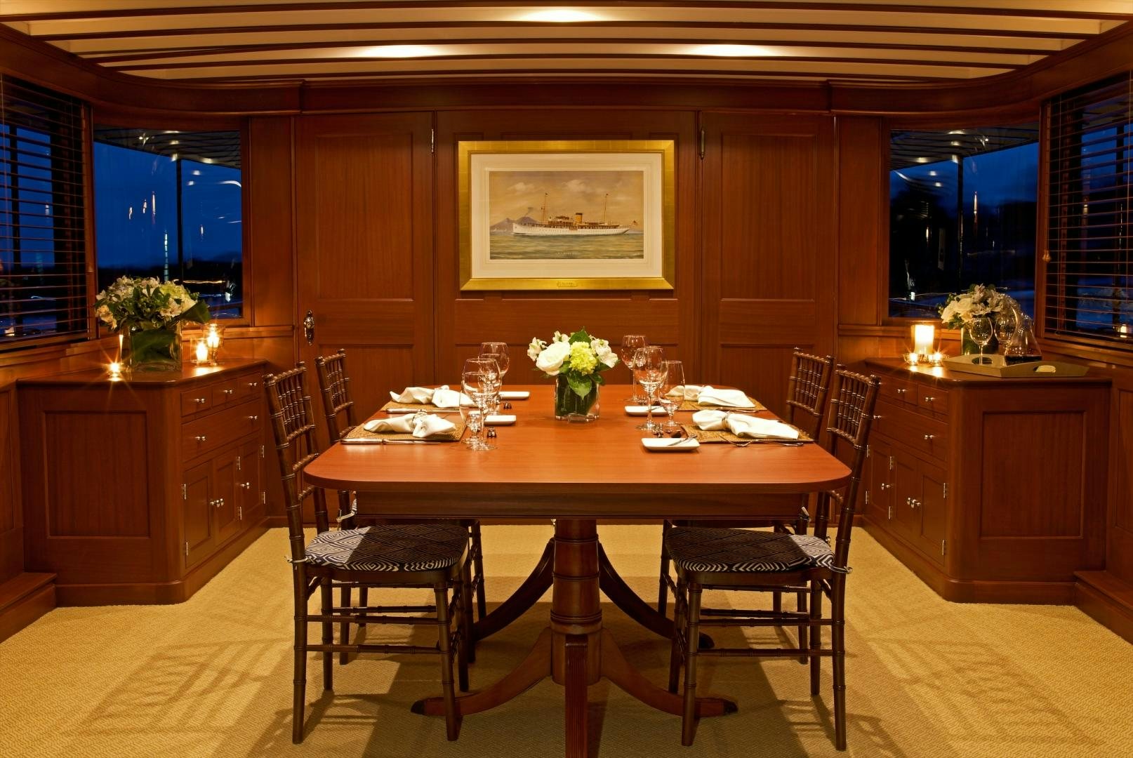 a dining table in a room aboard FREEDOM Yacht for Sale