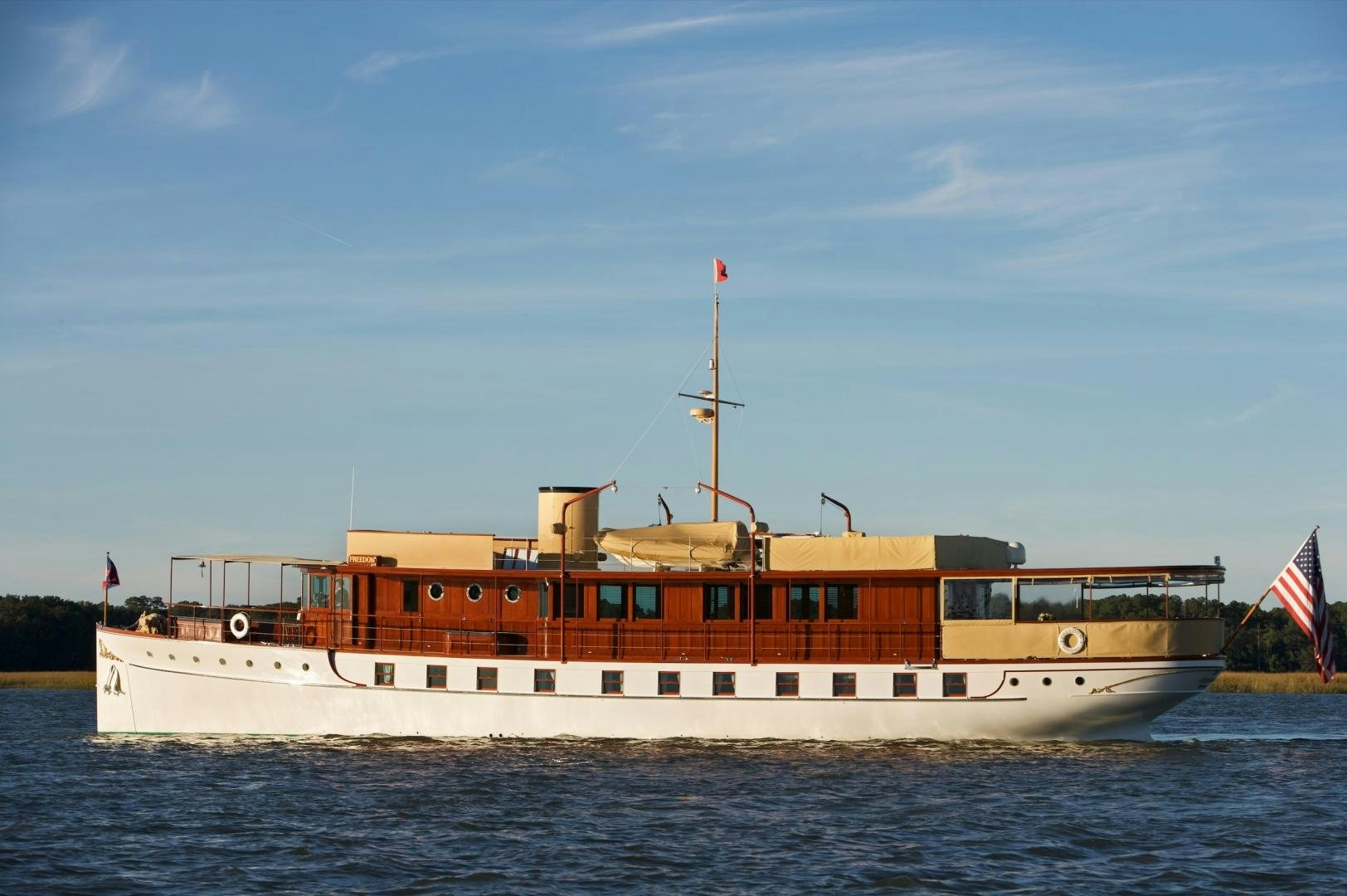 a large boat on the water aboard FREEDOM Yacht for Sale