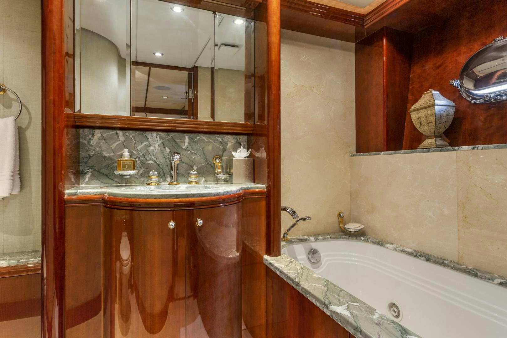a bathroom with a tub sink and cabinets aboard ANA’S INSPIRATION Yacht for Sale
