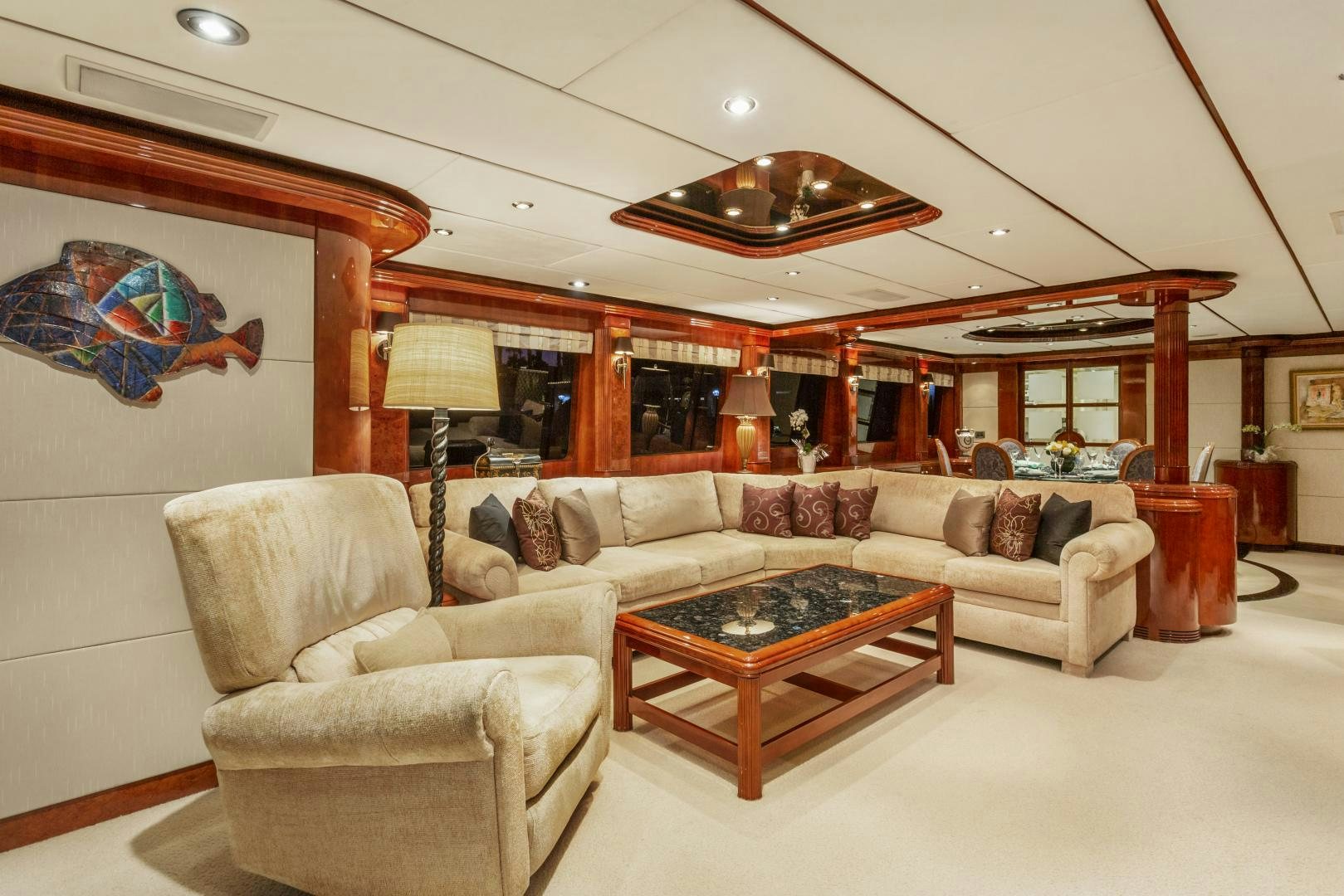 a living room with a large sofa and a coffee table aboard ANA’S INSPIRATION Yacht for Sale