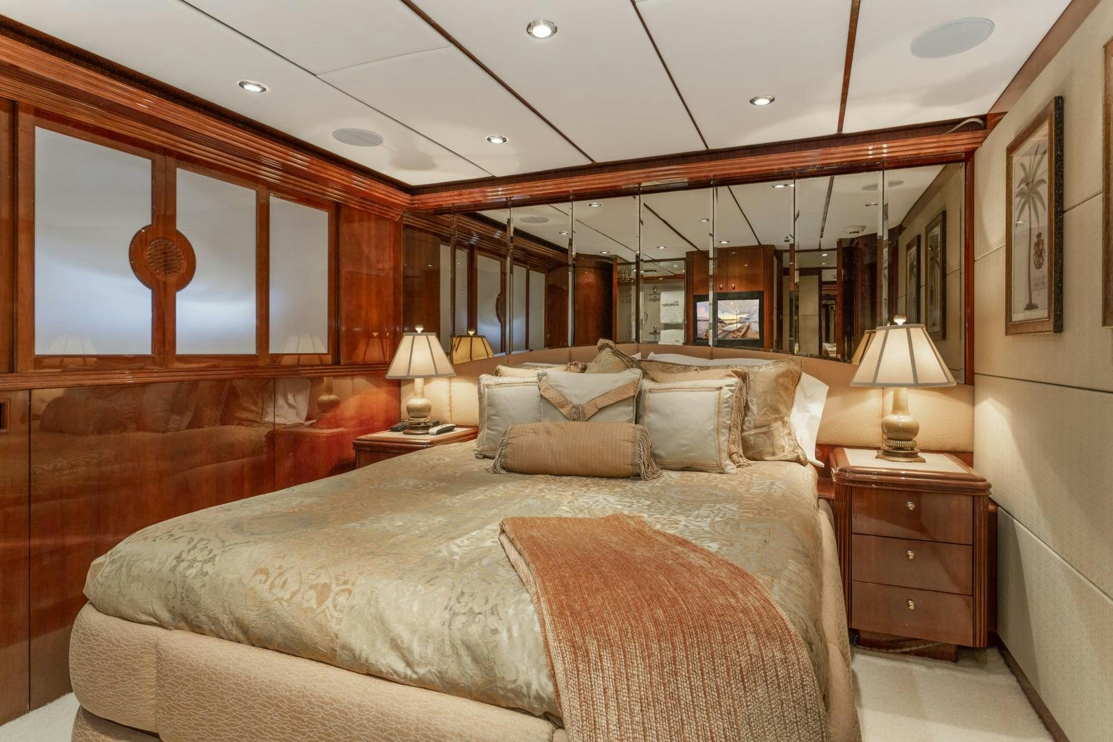 a bedroom with a bed and a mirror aboard ANA’S INSPIRATION Yacht for Sale
